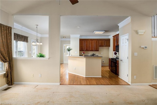 kitchen with baseboards, light colored carpet, black appliances, and crown molding