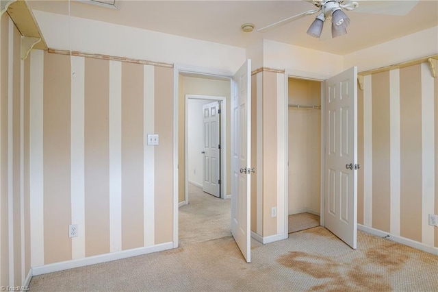 unfurnished bedroom featuring a ceiling fan, light colored carpet, and baseboards