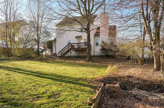 view of yard with stairway, a wooden deck, and fence