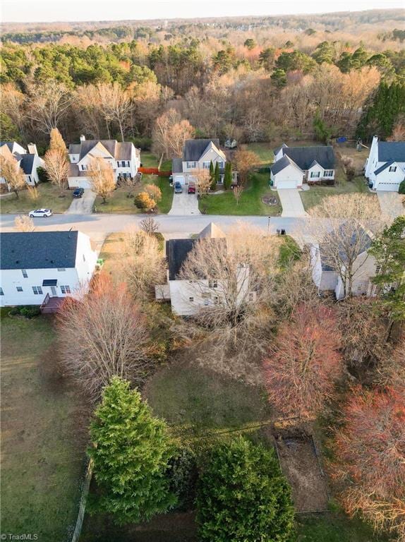 birds eye view of property with a wooded view