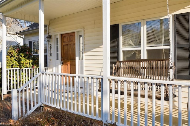 view of exterior entry featuring a porch