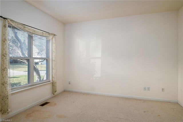 carpeted empty room with baseboards and visible vents