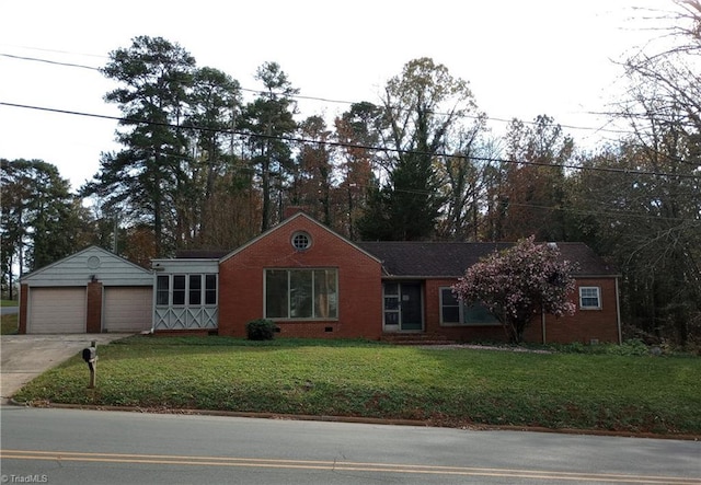 view of front of house featuring a garage, an outdoor structure, and a front yard