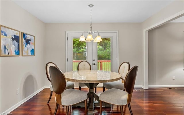 dining area with dark wood-style floors, a chandelier, baseboards, and french doors