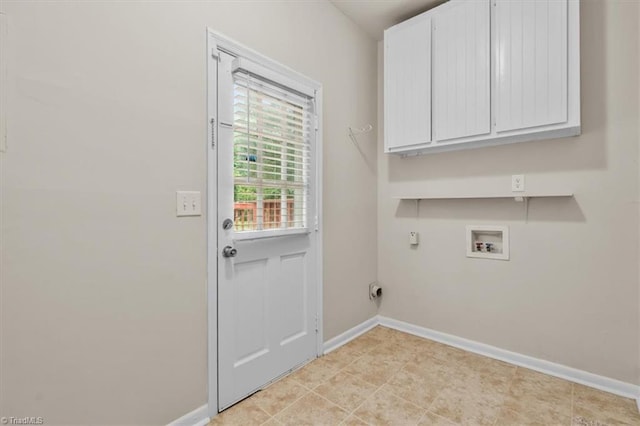 washroom with cabinet space, baseboards, and hookup for a washing machine