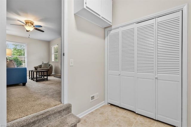 hall featuring baseboards and stairs
