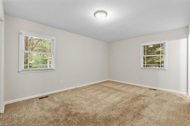 unfurnished room featuring carpet flooring and baseboards