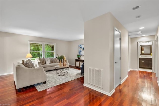 living area with wood finished floors and baseboards