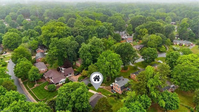 aerial perspective of suburban area with a forest