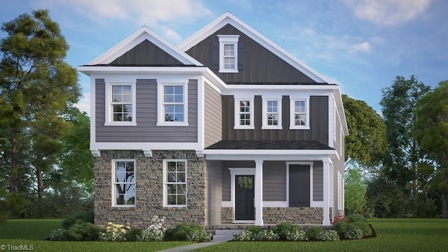 craftsman-style house with board and batten siding, a front yard, and stone siding