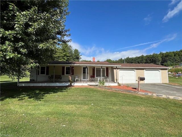 ranch-style house with driveway, an attached garage, a front lawn, and a porch