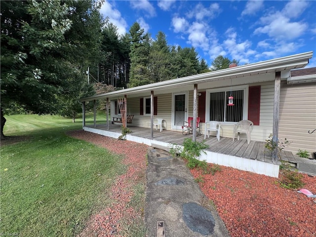 view of front of house featuring covered porch and a front lawn