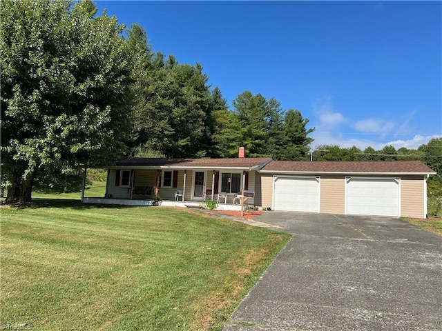 single story home featuring a chimney, a porch, a garage, driveway, and a front lawn