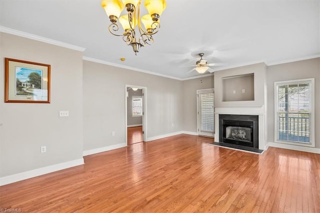 unfurnished living room featuring ceiling fan with notable chandelier, ornamental molding, and wood-type flooring