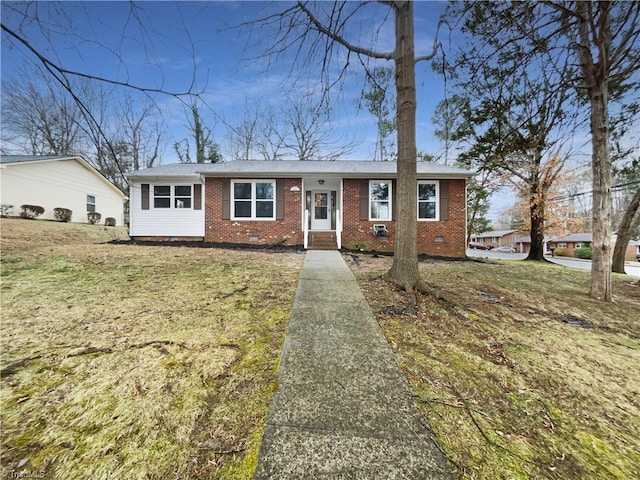 ranch-style home with crawl space, brick siding, and a front yard