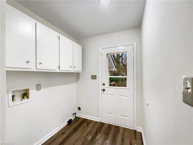 washroom with dark wood-style floors, cabinet space, baseboards, and washer hookup