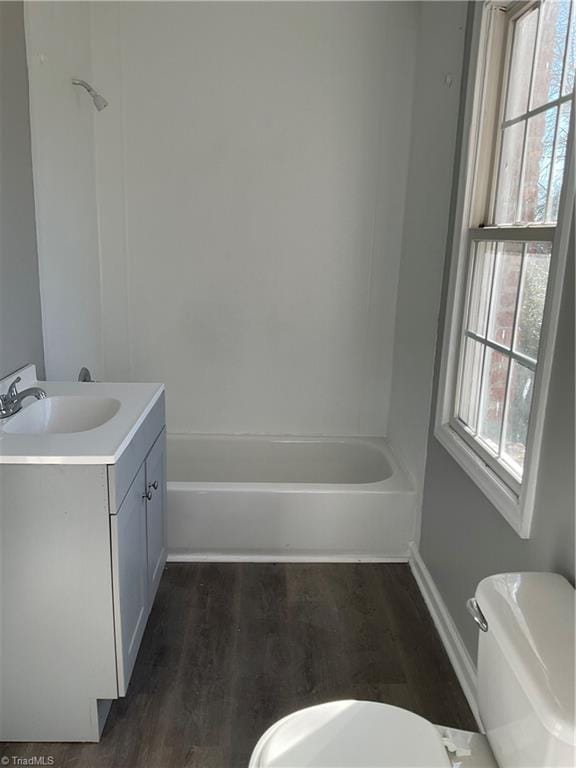 bathroom with hardwood / wood-style floors, vanity, and toilet