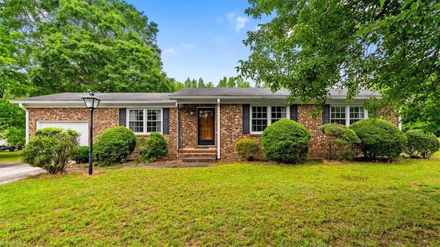 318 Sedalia Rd, Gibsonville, NC 27249 - ranch-style home with a front lawn, a garage, and brick siding