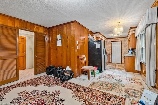 318 Sedalia Rd, Gibsonville, NC 27249 - entryway with a chandelier, crown molding, wooden walls, and light tile patterned floors