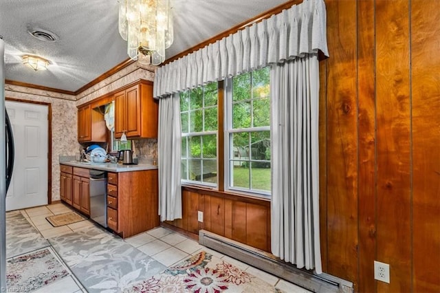 318 Sedalia Rd, Gibsonville, NC 27249 - kitchen with appliances with stainless steel finishes, a baseboard radiator, a chandelier, ornamental molding, and light countertops