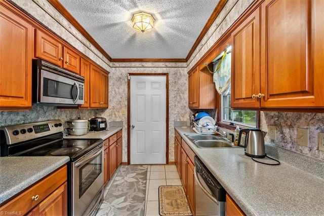 318 Sedalia Rd, Gibsonville, NC 27249 - kitchen featuring appliances with stainless steel finishes, crown molding, a sink, brown cabinetry, and a textured ceiling