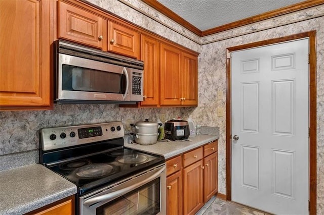 318 Sedalia Rd, Gibsonville, NC 27249 - kitchen featuring appliances with stainless steel finishes, crown molding, a textured ceiling, and brown cabinetry