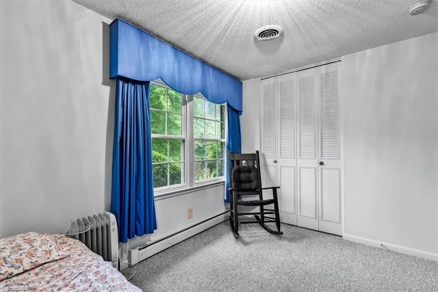 318 Sedalia Rd, Gibsonville, NC 27249 - carpeted bedroom featuring baseboard heating, radiator, a textured ceiling, and a closet