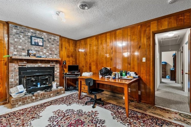 318 Sedalia Rd, Gibsonville, NC 27249 - carpeted home office with attic access, ornamental molding, a fireplace, wooden walls, and a textured ceiling