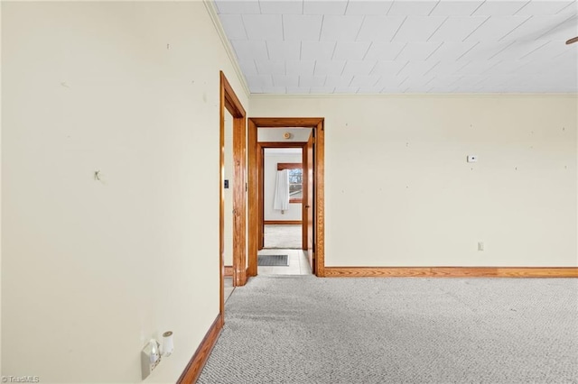 hall featuring ornamental molding and light colored carpet