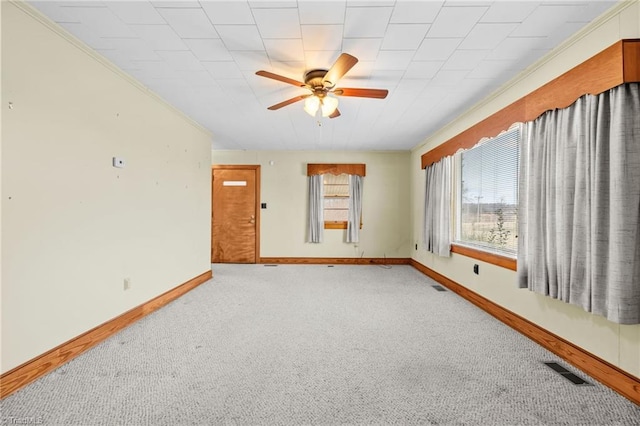 carpeted spare room with ceiling fan