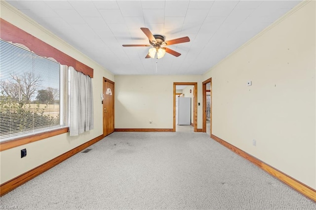 carpeted spare room with ceiling fan