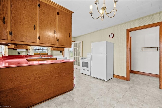 kitchen with decorative light fixtures, sink, white appliances, and a chandelier