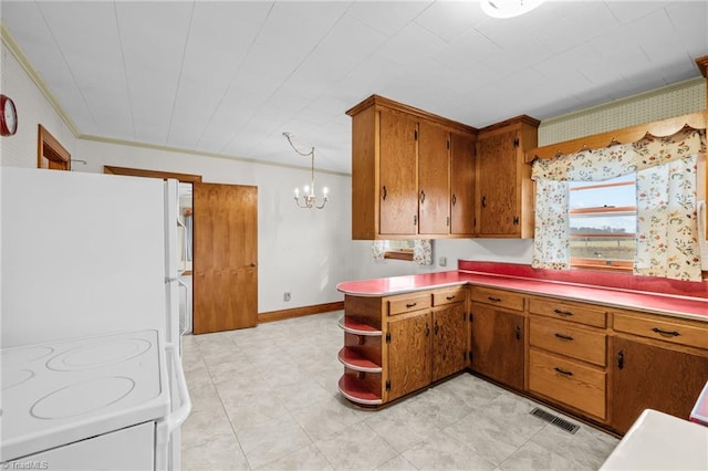 kitchen with white appliances, an inviting chandelier, hanging light fixtures, ornamental molding, and kitchen peninsula