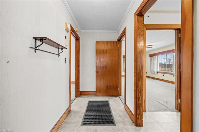 hallway with crown molding and light carpet