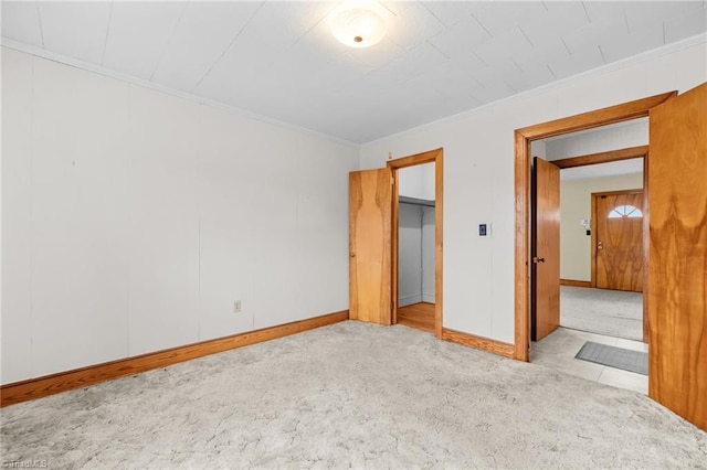 unfurnished bedroom featuring ornamental molding and light colored carpet