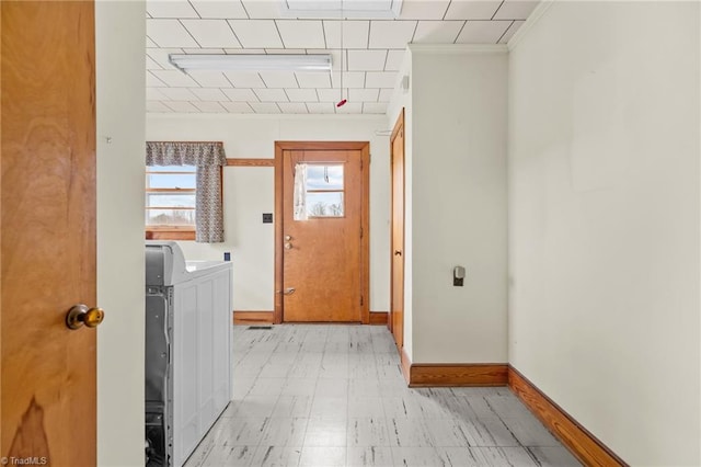 laundry area featuring washing machine and dryer and ornamental molding