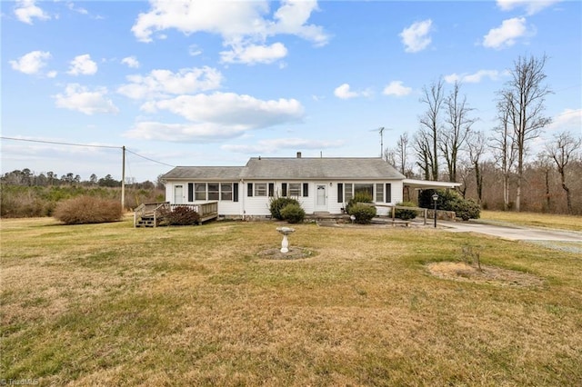 single story home featuring a wooden deck, a front yard, and a carport