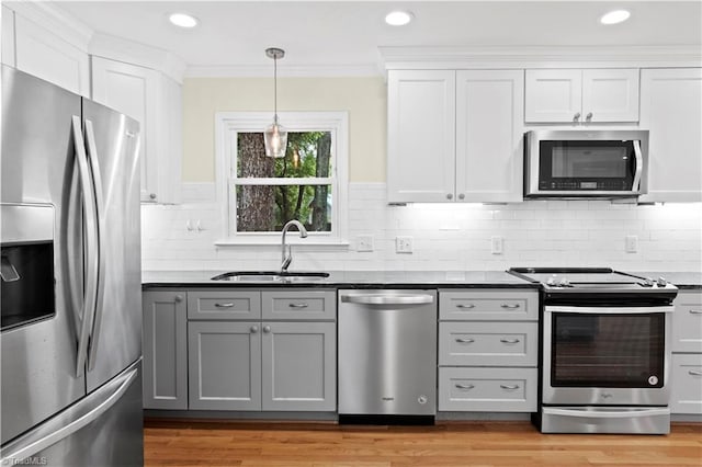 1022 Willowlake Rd, Winston-Salem, NC 27106 - kitchen with stainless steel appliances, a sink, white cabinetry, dark countertops, and tasteful backsplash