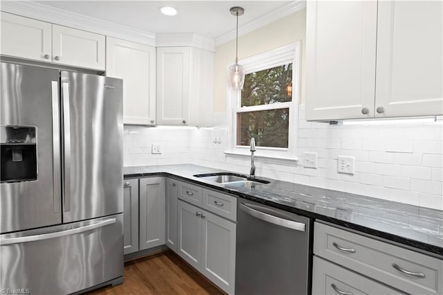 1022 Willowlake Rd, Winston-Salem, NC 27106 - kitchen featuring stainless steel appliances, a sink, dark stone countertops, decorative light fixtures, and white cabinets