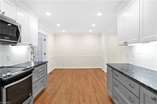 1022 Willowlake Rd, Winston-Salem, NC 27106 - kitchen featuring stainless steel appliances, decorative backsplash, dark stone counters, white cabinetry, and recessed lighting