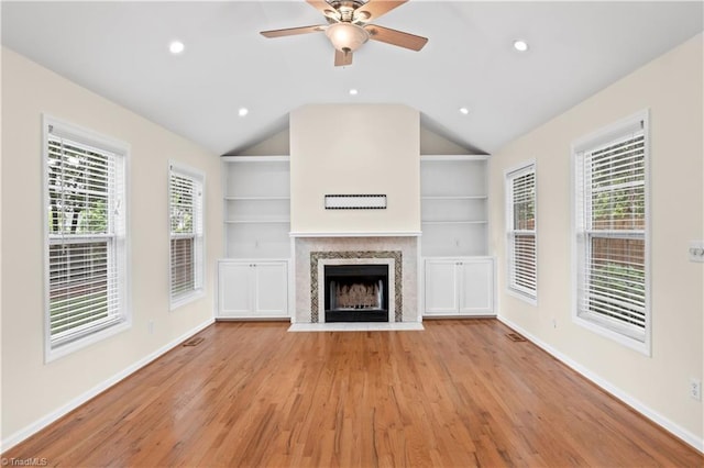 1022 Willowlake Rd, Winston-Salem, NC 27106 - unfurnished living room with light wood finished floors, vaulted ceiling, a fireplace with flush hearth, baseboards, and a ceiling fan