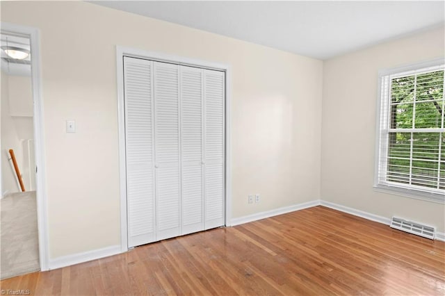 1022 Willowlake Rd, Winston-Salem, NC 27106 - unfurnished bedroom with wood finished floors, baseboards, and a closet
