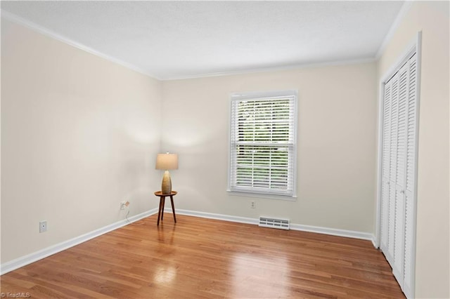 1022 Willowlake Rd, Winston-Salem, NC 27106 - unfurnished bedroom featuring ornamental molding, wood finished floors, baseboards, and a closet