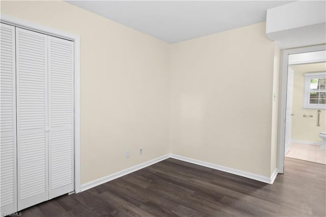 1022 Willowlake Rd, Winston-Salem, NC 27106 - unfurnished bedroom with dark wood-style floors, baseboards, and a closet