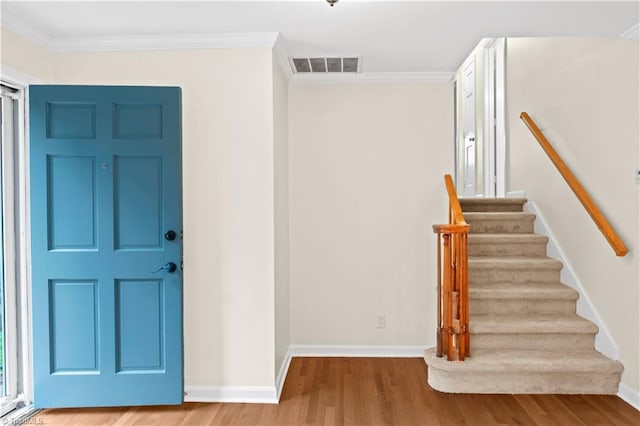 1022 Willowlake Rd, Winston-Salem, NC 27106 - entryway featuring wood finished floors, crown molding, stairway, and baseboards