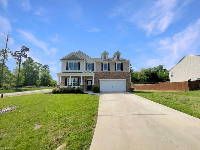 traditional home featuring a front yard, covered porch, driveway, an attached garage, and fence