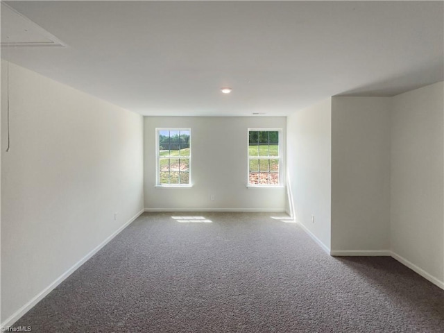 empty room with baseboards and carpet flooring