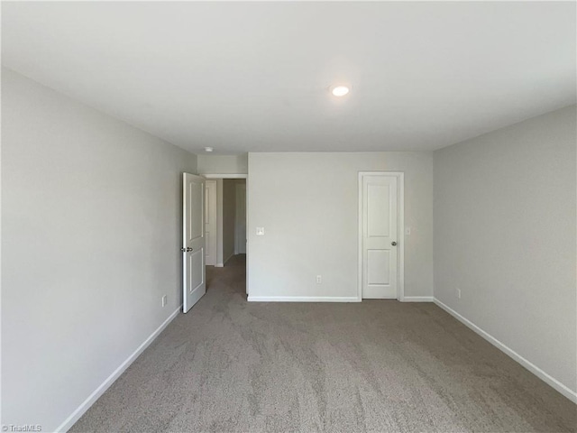 carpeted spare room with recessed lighting and baseboards