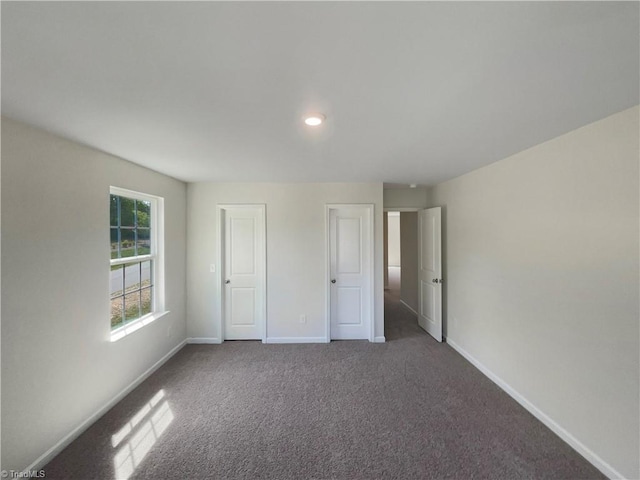 unfurnished bedroom with recessed lighting, carpet flooring, and baseboards