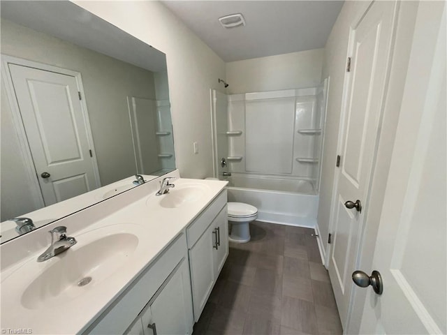 full bathroom featuring double vanity, visible vents, tub / shower combination, and a sink